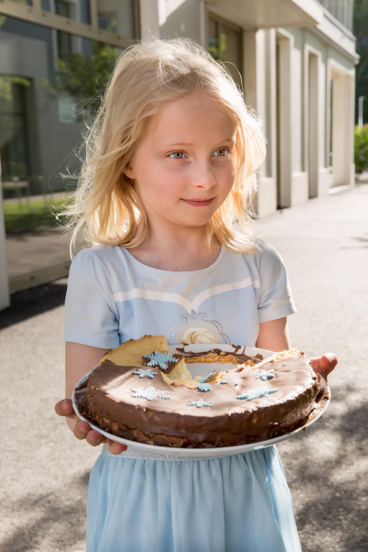 Girl with birthday cake, sunlight