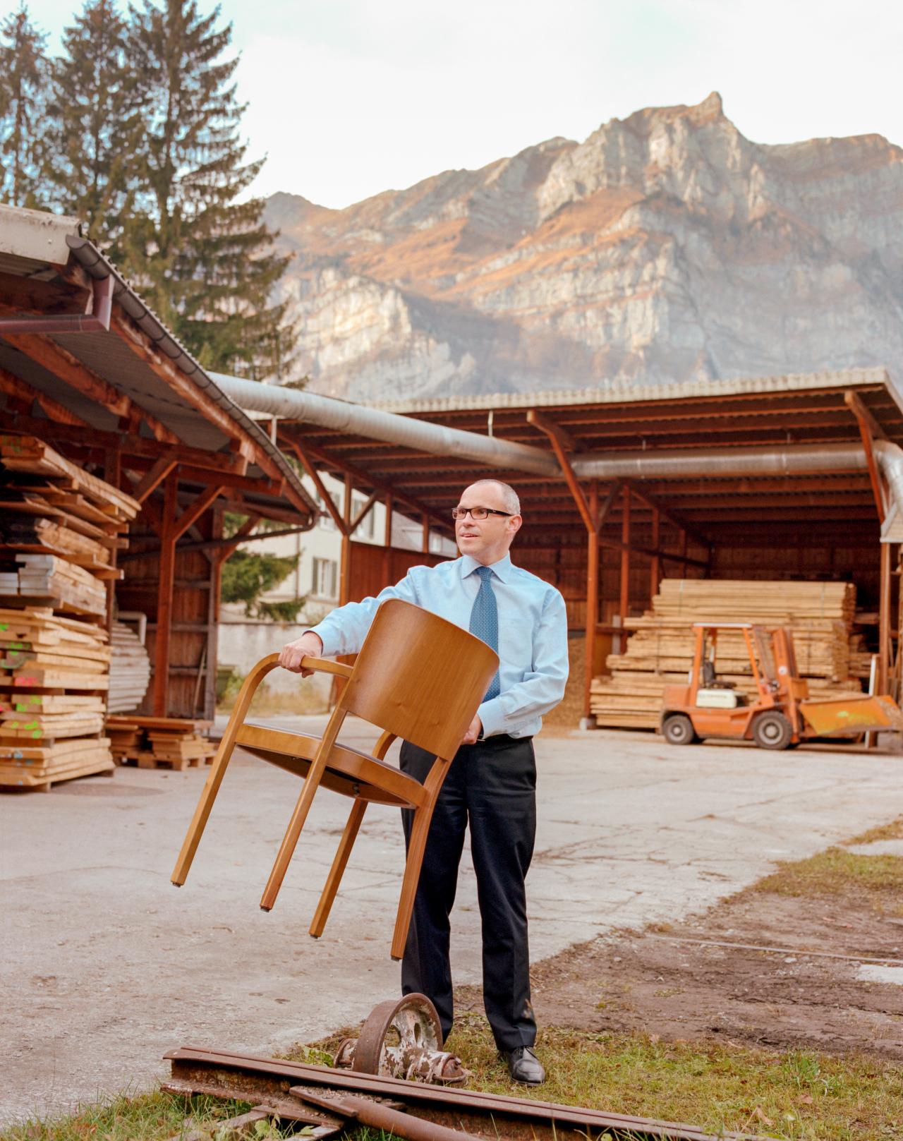 man holding chair