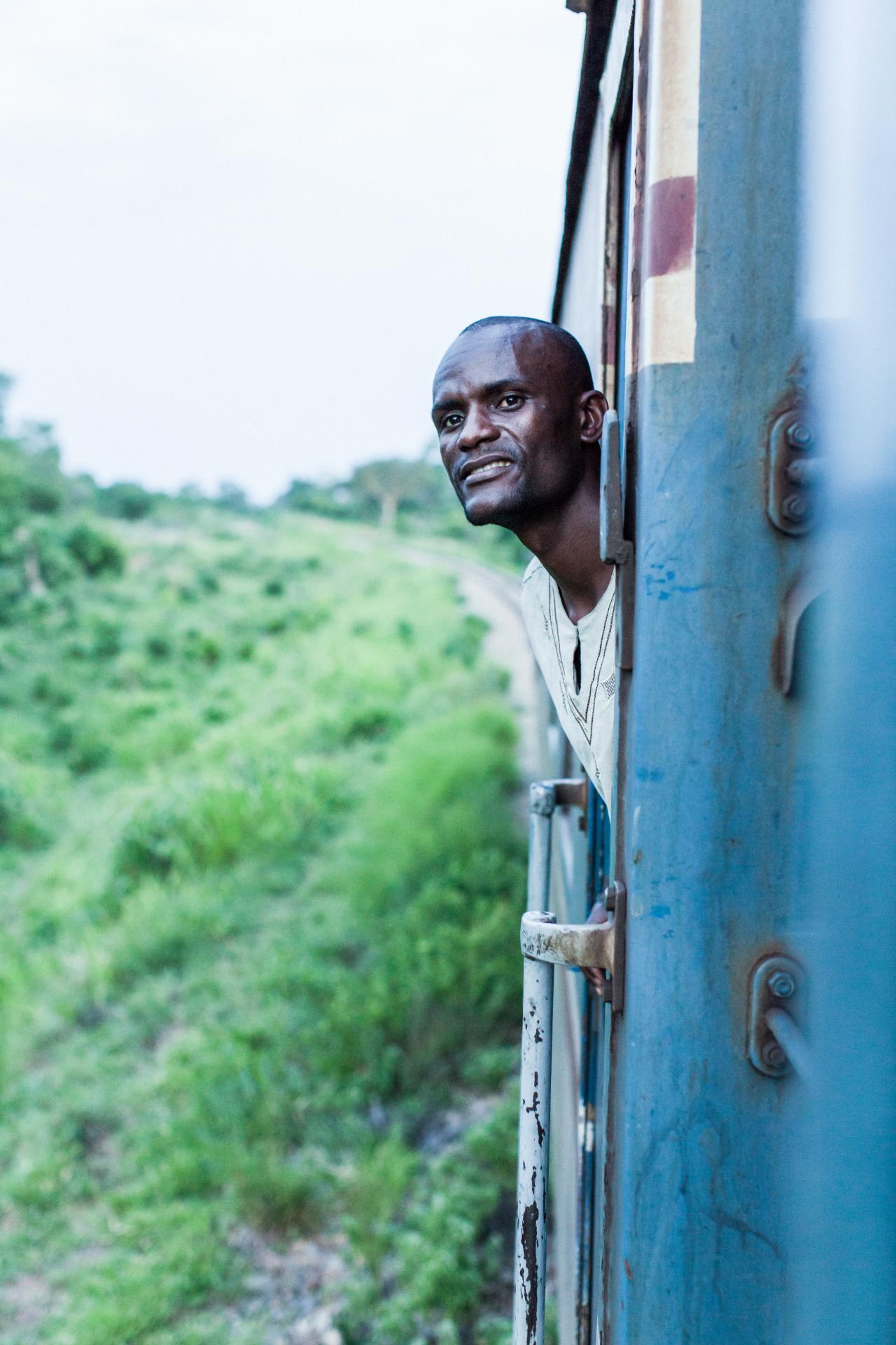 man looking out trainwindow