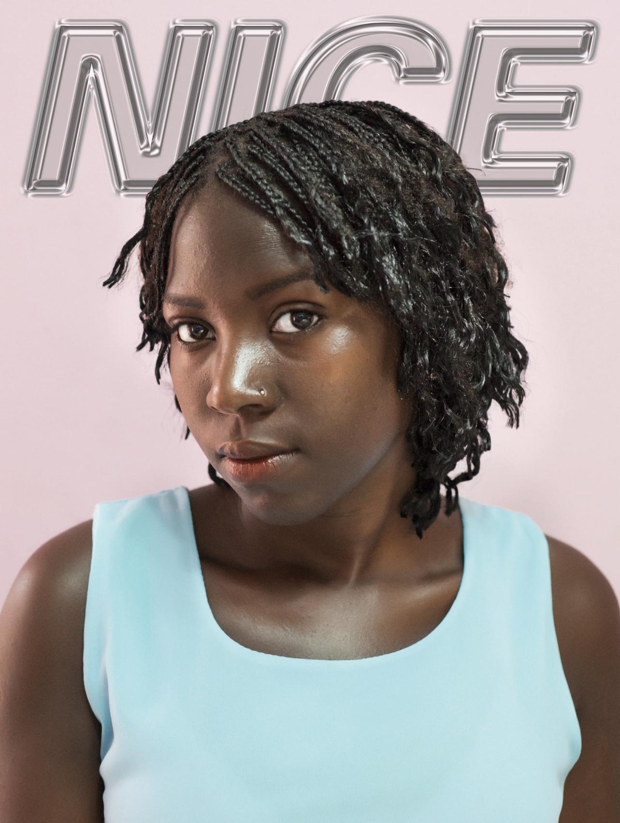 portrait of african girl with braids pink backdrop