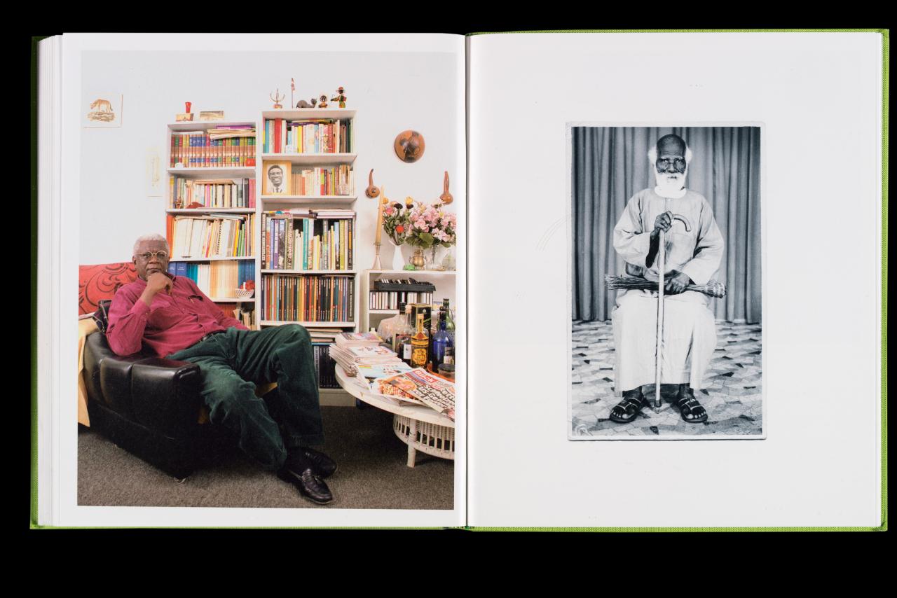 man sitting in chair and old photograph