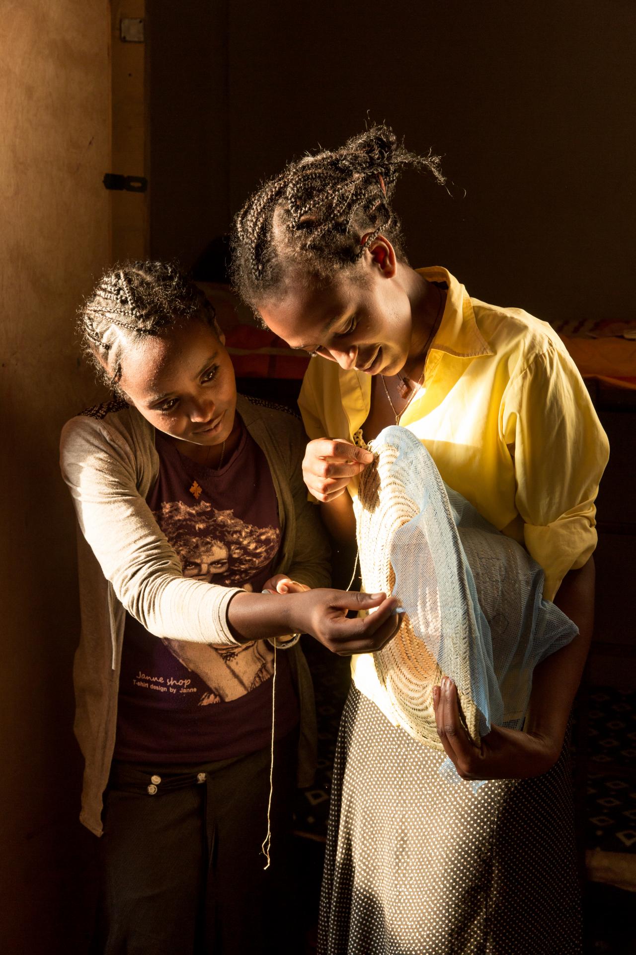 two beekeepers sewing